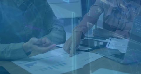 Business Professionals Analyzing Financial Data on Digital Charts