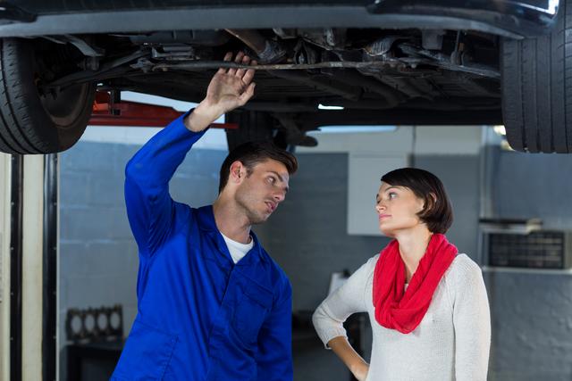 Mechanic explaining car issue to customer in repair garage - Download Free Stock Images Pikwizard.com