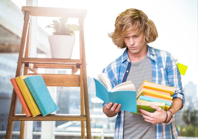 Teen boy holding and reading books standing beside a ladder bookshelf with a potted plant in bright study environment. Ideal for content on education, youth learning habits, student life, home study spaces, and educational articles.