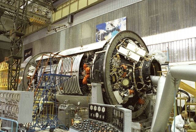 Russian engineers are meticulously working on the Functional Cargo Block (Zarya), destined for the International Space Station (ISS). This component was crucially funded by the United States and crafted in Russia at Khrunichev State Research and Production Space Center. Thorough pre-launch tests are being conducted to ensure its readiness before its launch on November 20, 1998, by a Russian Proton rocket from the Baikonu Cosmodrome. This versatile supply module (Zarya or 'Sunrise' in Russian) became the very first piece of the ISS's extensive framework. Usage ideas include illustrating space construction processes, showcasing aerospace engineering, or highlighting international space collaboration.