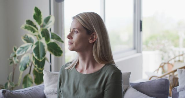 Thoughtful Woman Relaxing at Home by Window - Download Free Stock Images Pikwizard.com