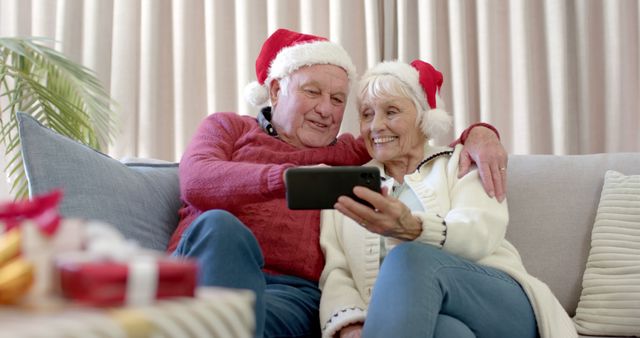 Happy Senior Couple in Santa Hats Taking a Selfie During Christmas - Download Free Stock Images Pikwizard.com