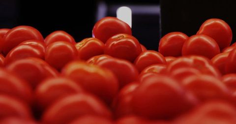 Vibrant ripe tomatoes displayed at produce section