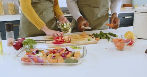 Diverse Friends Preparing Vegetables Together in Modern Kitchen