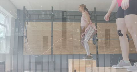 Women Engaging in Cross Training with Data Overlay in Gym