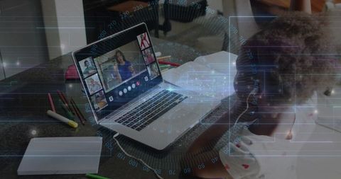 Child Participating in Remote Learning at Kitchen Table with Laptop and Pencils