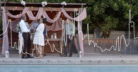 Poolside wedding ceremony under draped pergola exchanging vows with romantic string lights
