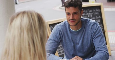 Couple Enjoying Coffee Date Outdoors in Urban Setting