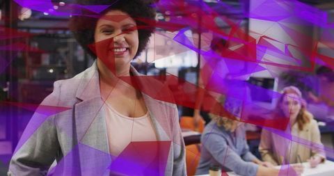 Smiling professional woman leading collaborative team in vibrant modern coworking space