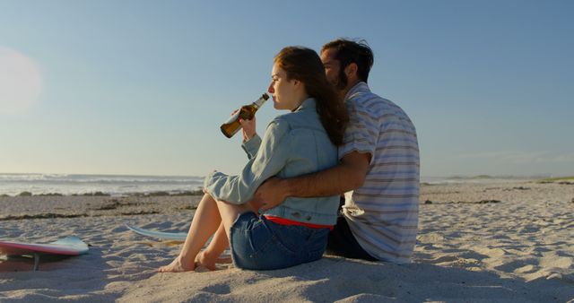 Couple having beer at beach on a sunny day. Couple spending time together 4k