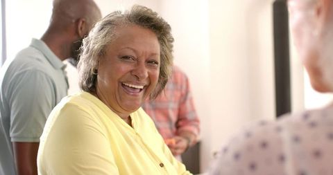 Smiling Senior Woman Bonding at Indoor Social Gathering - Download Free Stock Images Pikwizard.com