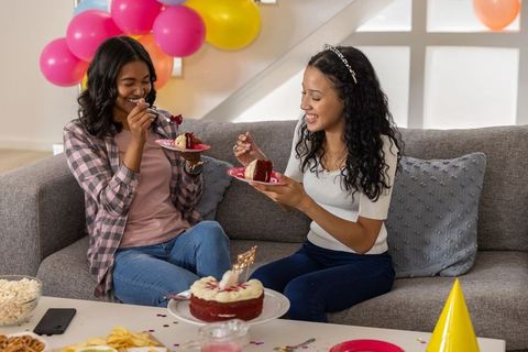 Diverse Friends Enjoying Red Velvet Cake Celebrating Birthday in Living Room