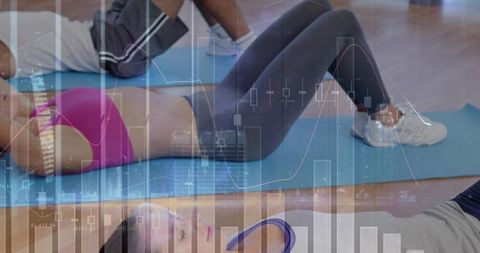 Group performing mat exercises with fitness analytics overlay and financial chart graphics
