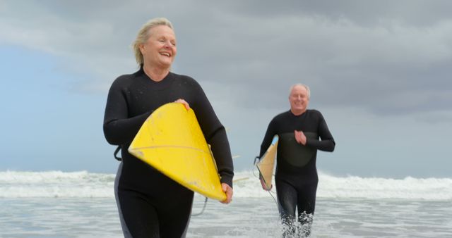 Senior Couple Enjoying Surfing on a Cloudy Day - Download Free Stock Images Pikwizard.com