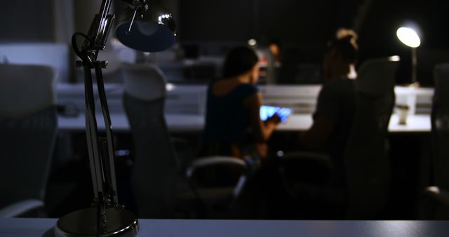 Colleagues Working Late in Dimly Lit Office - Download Free Stock Images Pikwizard.com