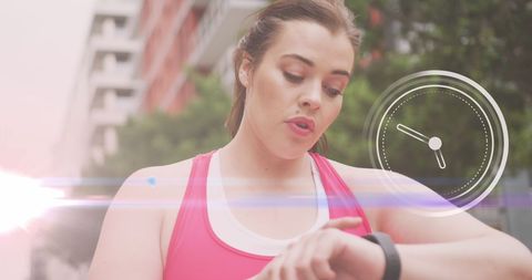 Plus Size Woman Checking Fitness Tracker While Exercising in Urban Area