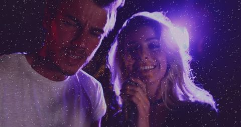 Dynamic Duo Performing on Stage with Vibrant Lights and Sparkles