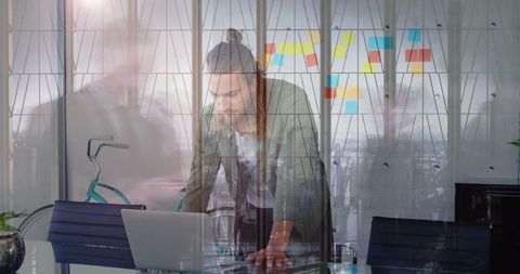 Modern Office Environment with Focused Employee At Laptop