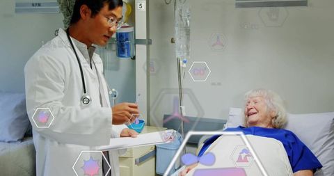 Asian Doctor Caring for Elderly Hospitalized Patient with IV Tech Overlay