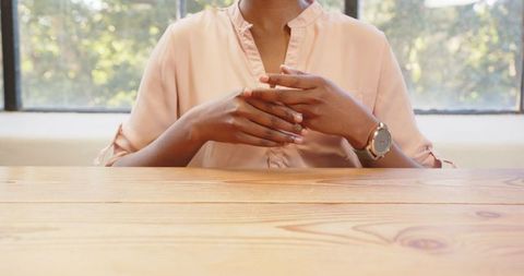 Woman Relaxing at Wooden Table with Stylish Accessories