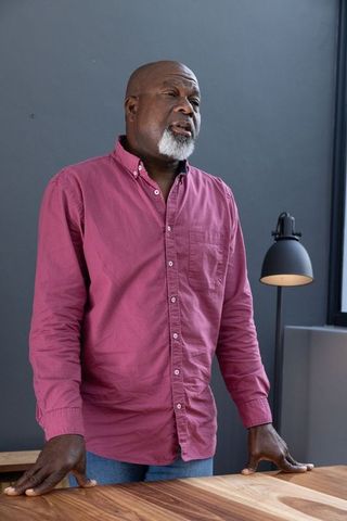 Senior Man Speaking in Home Office With Large Desk