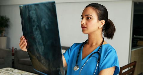 Female doctor analyzing x-ray results in hospital environment