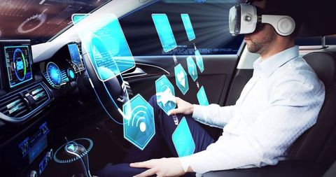 Businessman experiencing self-driving car with vr and holographic interface