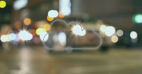 Colorful Neon Cloud Sign Glowing Against Blurred Night Cityscape