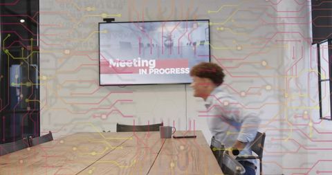 Businesswoman leaving meeting room with meeting in progress screen and circuit overlay