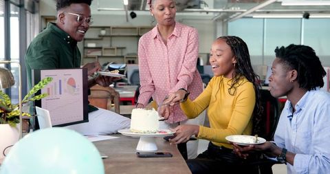 Colleagues Celebrating with Cake in a Modern Office Environment