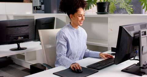 Businesswoman Engaging with Technology in Modern Office Environment - Download Free Stock Images Pikwizard.com