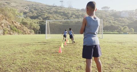 Kids Practicing Soccer Drills on Sunny Field
