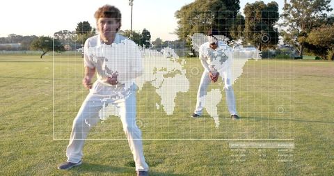 Crouching cricketers preparing to catch ball on sunlit field with world map hud overlay