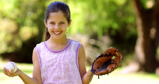 Smiling Young Girl Playing Baseball in Park on Sunny Day - Download Free Stock Images Pikwizard.com