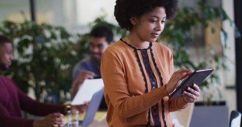 Young Woman Using Digital Tablet in Modern Office