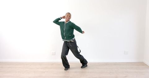 Energetic Man Dancing Joyfully in Spacious Room
