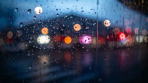 Rain Drops on Window Creating Bokeh Urban Nightscene