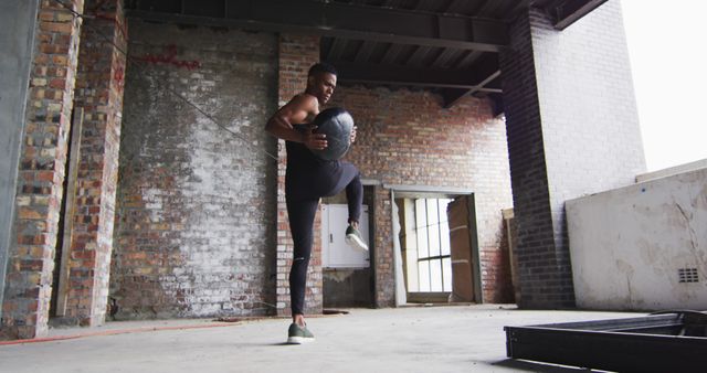 Man Balancing Training Ball during Intense Workout in Industrial Gym - Download Free Stock Images Pikwizard.com