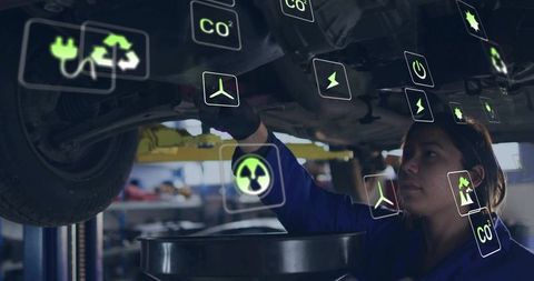 Female Mechanic Inspecting Car with Virtual Eco-Friendly Icons Overlay