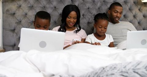 Family Enjoying Quality Time in Bed with Digital Devices - Download Free Stock Images Pikwizard.com