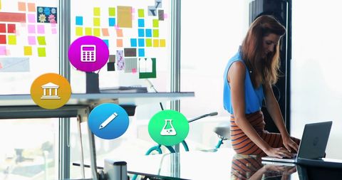 Innovative businesswoman using laptop with digital interface icons