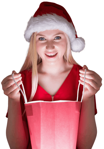 Joyful woman in Santa hat opening transparent festive gifting bag with excitement