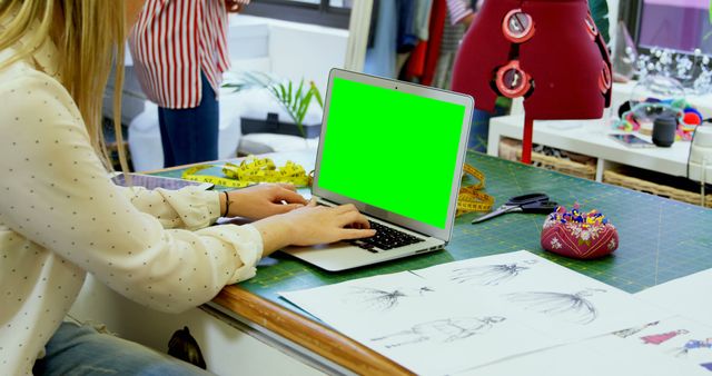 Fashion Designer Using Laptop with Green Screen in Studio - Download Free Stock Images Pikwizard.com