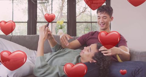 Happy LGBTQ Couple Relaxing Together with Smartphone