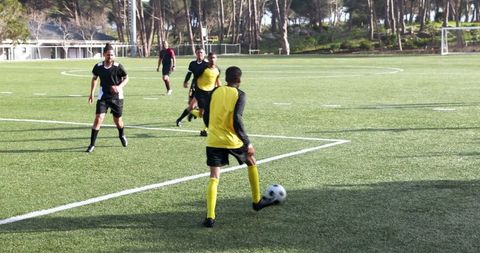 Soccer Players Practicing Teamwork and Strategy on Field