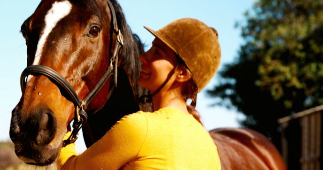 A middle-aged Caucasian woman shares a moment with her horse, bathed in sunlight, with copy space - Download Free Stock Photos Pikwizard.com
