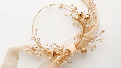 Elegant gold hoop wreath with cream ribbon, white berry sprigs and jingle bells