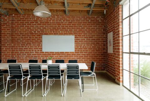 Modern industrial meeting room with exposed brick walls