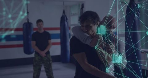 Instructor demonstrating combat hold in martial arts dojo