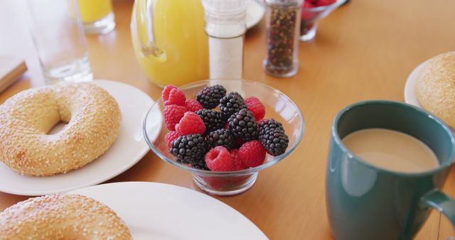 Close up of fresh bread and fruit on breakfast with coffee and orange juice on table. Food and lifestyle concept.